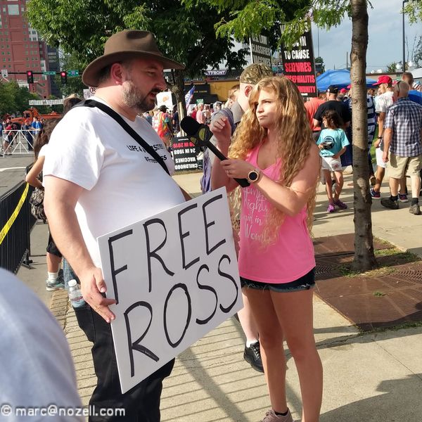 protestor holding a "Free Ross" sign